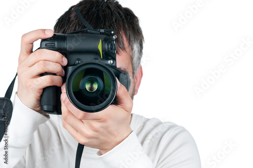 Photo: Young man with camera, isolated on white background, focus is on Young man with camera, isolated on white background, focus is on