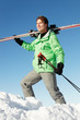 Middle Aged Man On Ski Holiday In Mountains