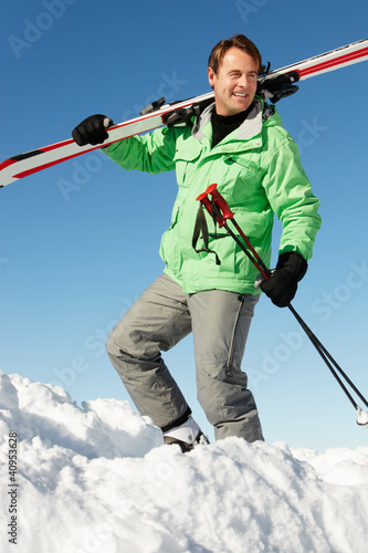 Photo: Middle Aged Man On Ski Holiday In Mountains Middle Aged Man On Ski Holiday In Mountains