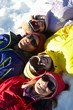 Overhead View Of Teenage Family Lying In Snow On Ski Holiday In