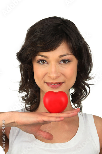 Photo: Brunette girl with heart in hand Brunette girl with heart in hand