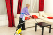Photo: Woman cleaning room with vacuum Woman cleaning room with vacuum