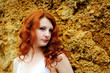 Photo: Woman portrait standing near the rock. Woman portrait standing near the rock.