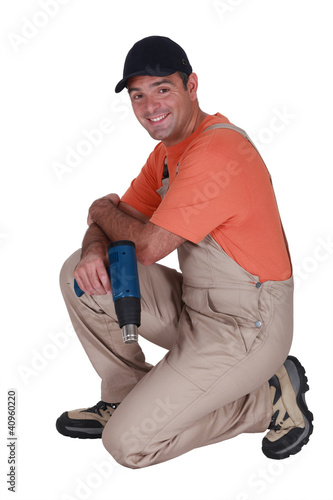 Photo: Handyman holding a screw gun Handyman holding a screw gun