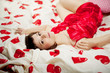 Woman in bed with hearts