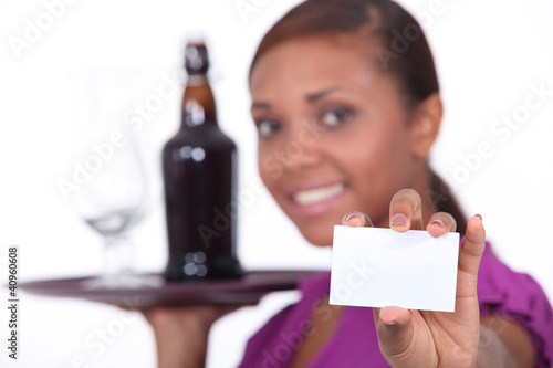 Photo: Waitress carrying tray and holding business card Waitress carrying tray and holding business card