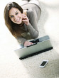 Smiling woman using her laptop in the living room.