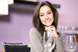 Portrait of young woman in kitchen