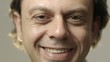 Portrait of happy caucasian adult man smiling at camera