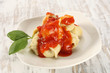 single plate with ravioli and basil