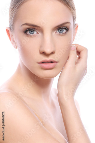 Photo: Beautiful woman with clean face over white background Beautiful woman with clean face over white background
