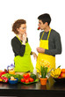 Couple eating strawberries in kitchen