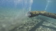 Outlet pipe discharging some form of waste into the ocean.