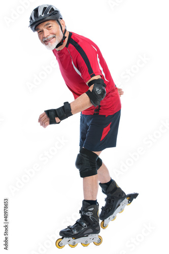 Foto: senior man inline skating senior man inline skating