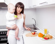 Photo: woman with baby cooking woman with baby cooking