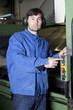 Metalworker pushing the button