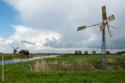 Photo: Old metal windmill in a Dutch landscape Old metal windmill in a Dutch landscape