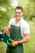 Gardener with hedge trimmer