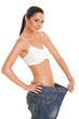 Pretty woman shows her weight loss by wearing an old jeans