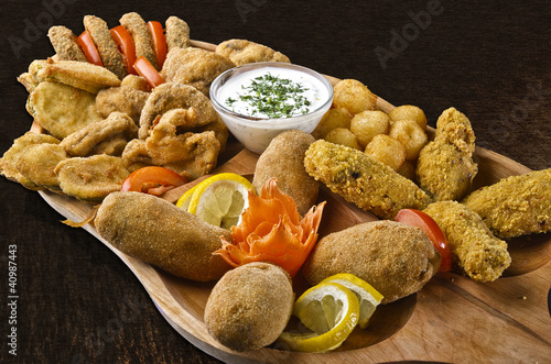Foto: Rustic tray with various meats and cheese balls - isolated Rustic tray with various meats and cheese balls - isolated