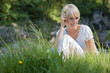 Frau sitzt in der Wiese