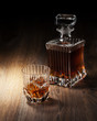 glass and bottle with whiskey on a woden table glass and bottle with whiskey on a woden table