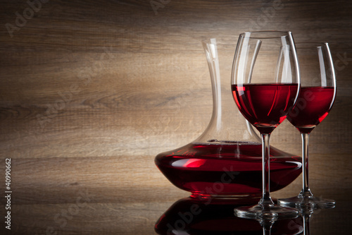 Photo: two Wine glass and decanter on a wooden Background two Wine glass and decanter on a wooden Background