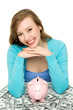 Woman with piggybank and dollar bills