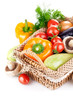 fresh vegetables with leaves in the basket isolated on white