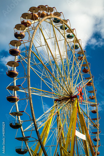 Photo: Funfair park on blue sky background Funfair park on blue sky background