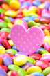 Pink heart and colorful chocolate smarties