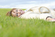 A happy woman laying on grass A happy woman laying on grass