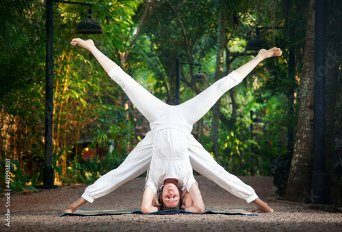 Photo: Couple yoga head stand pose Couple yoga head stand pose