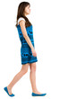 back side view of going young brunette girl .