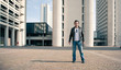 Young casual man portrait with building background.