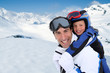 Father carrying son on his back at the mountain