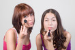 girls applying make up