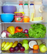 refrigerator full of healthy fruits, vegetables and dairy