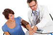 Male doctor checking woman blood pressure - white background