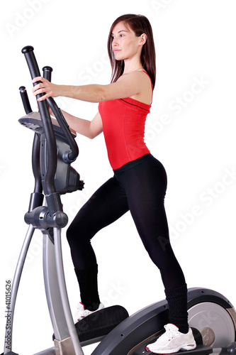 Photo: girl fitness exercise with cross trainer girl fitness exercise with cross trainer