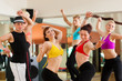 Zumba or Jazzdance - young people dancing in studio