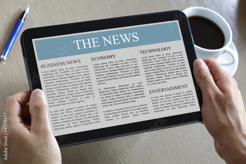 Photo: Digital tablet showing news Digital tablet showing news