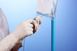 Nurse doing infusion on blue background