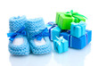 beautiful gifts and baby's bootees isolated on white