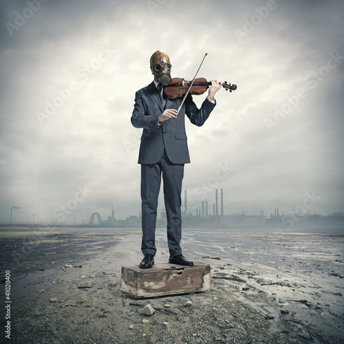 Photo: businessman with gas mask, plays the violin businessman with gas mask, plays the violin