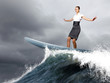Businesswoman surfing on the sea waves