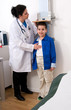 Photo: Female doctor measuring height of a child patient in clinic Female doctor measuring height of a child patient in clinic