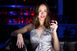 Young woman in night club with a drink