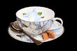 tea cup, a teaspoon of sugar on a saucer tea cup, a teaspoon of sugar on a saucer