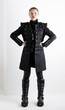 standing woman wearing extravagant clothes and boots